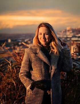 Beautiful young woman smiling during a scenic sunset outdoor portrait session.
