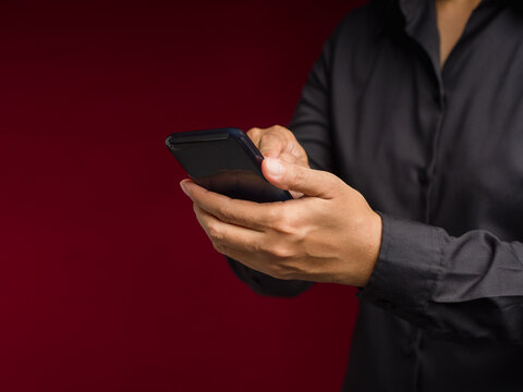 Person Using Smartphone Against Red Background