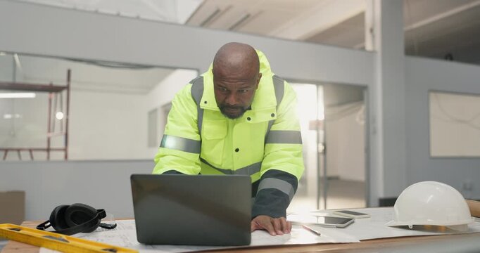 Black man, laptop and blueprint for construction in building, strategy and compare plans for renovation. Mature architect, technology or review digital floorplan with documents for engineering