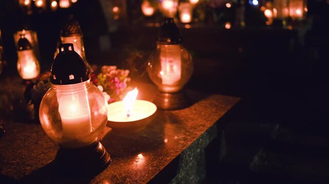 Candles On Grave In Cemetery On All Saints' Day