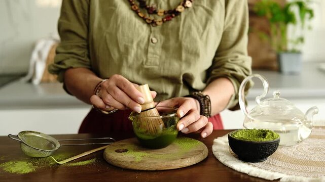 Close-Up Of A Woman Whisking Matcha Green Tea