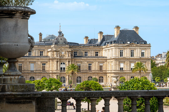 looking up at palace in the jardin du Luxembourg in Paris city centre public park with green trees and clear blue sunny skies overhead in summer