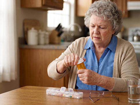 Older Woman Struggling With Medication Packaging