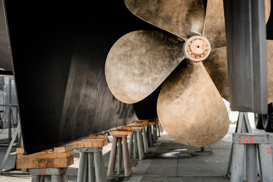 Close up detail of the propeller of a superyacht hauled out in shipyard for maintenance work