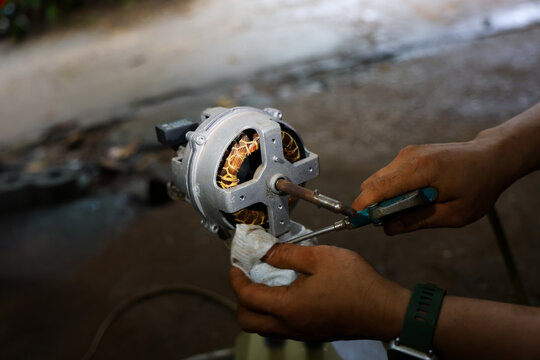 Motor repair mechanical repair electrical motor hand tool technician hand copper winding metal housing workshop maintenance