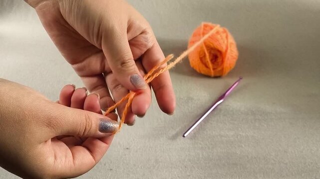 Woman tying the first knot, handmade craft, fine motor skills and concentration concept.