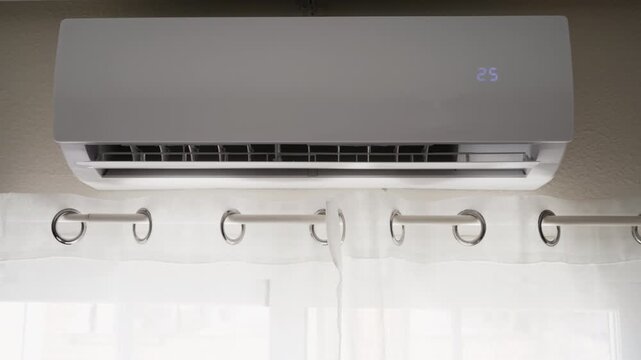 Close-up of air conditioner display as temperature setting increases to 26 degrees Celsius, illustrating indoor temperature adjustment, climate control, energy management and home comfort