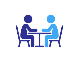 Fototapeta premium Two people sitting at a table having a conversation