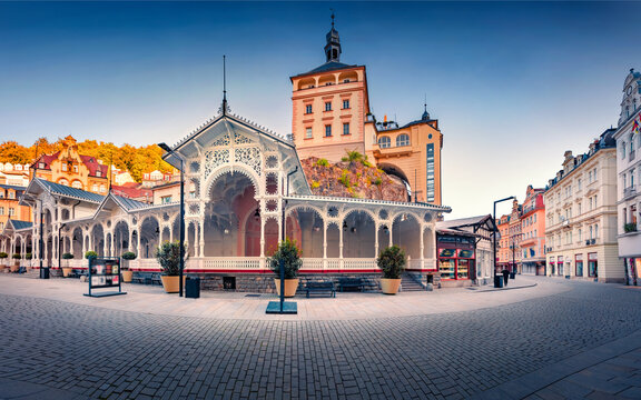 Beautiful morning view of popular tourist attraction - Market Colonnade and Castle Tower on background. Stunning summer cityscape of Karlovy Vary (Carlsbad) town, Czech Republic.