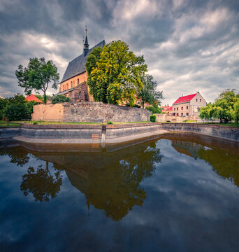 Dramatic evening view of Saint Gothard Catholic Church. Gloomy summer cityscape of Slany town, Kladno District, Central Bohemian Region, Czech Republic, Europe. Traveling concept background.