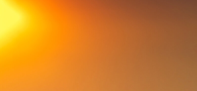 Smooth warm orange and yellow gradient background featuring a luminous blurred glow from the upper left corner, evoking a soft sunrise or sunset light for versatile overlays