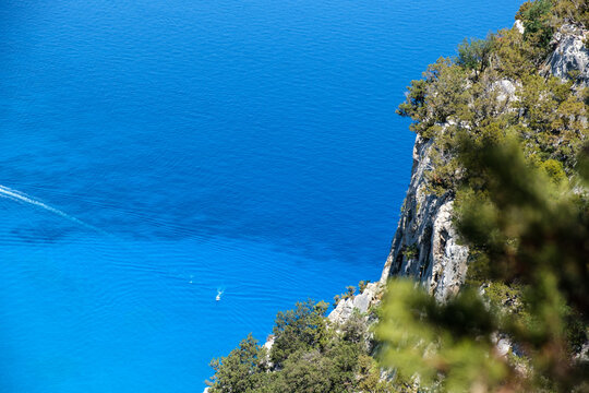 aerial closeup on the amazing water colours of Cala Goloritze, Orosei, with mediterranean shrubs, world's number one beach, outdoors, trekking, sailing, swimming, 