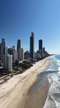 Surfers Paradise aerial footage of the city skyline meeting the Pacific Ocean, Gold Coast, Queensland Australia - vertical video