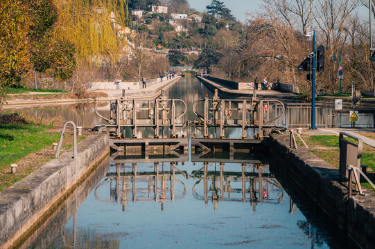 &Eacute;cluse sur le canal &agrave; Agen avec reflets d'automne et promeneurs