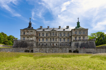 Fototapeta premium The grand facade of the Pidhirtsi Castle under the blue sky in Lviv oblast, Ukraine
