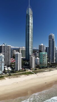 Surfers Paradise aerial drone footage over the beach, surf and high-rise skyline, Gold Coast, Queensland Australia - vertical video
