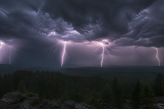 Lightning Storm Over Forest Creates Dramatic Environmental Photography with Electric Skies and Moody Natural Atmosphere