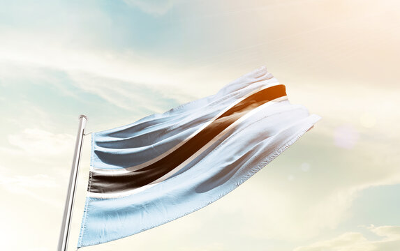 Botswana national flag waving in sky.