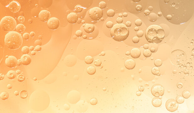 Abstract yellow water bubbles essential oil beauty collagen Serum Repair cell background.