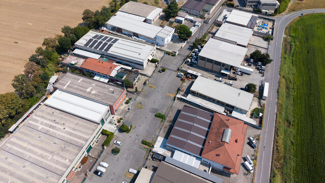 Aerial view of logistics warehouses, production buildings and workshops in San Giuliano Milanese, Lombardy, Italy.