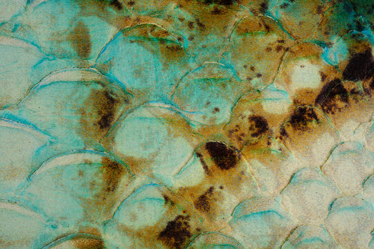 Turquoise reptile leather texture close up with glossy snake scale surface and vintage pattern