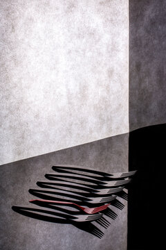 Still life with red and black forks