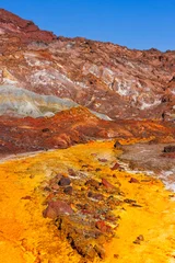 Colorful landscape of Hormuz Island, Iran, with rugged mountains, mineral-rich rocks and eroded barren terrain under bright sunlight © Inna