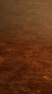 The view shows the surface of Mars at sunset featuring reddish soil and rocky ground. The atmosphere has a warm glow. This scene captures the Martian landscape without human presence.