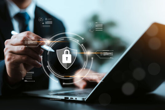 Businessman using digital pen to interact with cyber security shield and padlock icon interface. Concept of data protection, network safety, information privacy, and enterprise IT security.