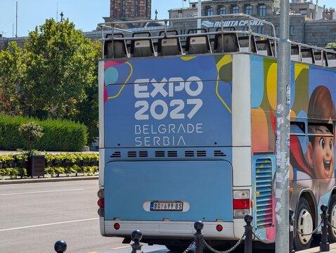 02 August 2026, Belgrade, Serbia: Expo 2027 advertising covers a tour bus parked on a Belgrade boulevard during preparations for the international specialized exhibition. 