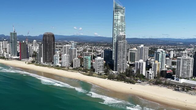Surfers Paradise aerial view of waves rolling onto golden sand below the towers, Gold Coast, Queensland Australia
