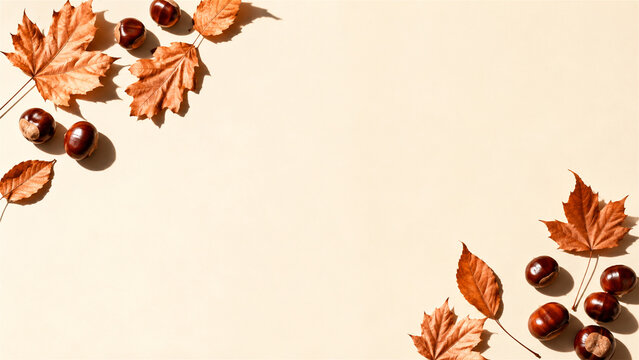 autumn maple leaves and chestnuts arranged around blank copy space. Seasonal nature background for fall greeting card, harvest announcement, Thanksgiving message, or editorial design