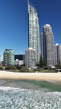 Surfers Paradise drone flight along the beachfront skyline and coastline, Gold Coast, Queensland Australia - vertical video
