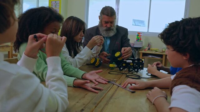 Teacher child classroom robot science education student learning experiment technology group lesson with curious learners around table in school workshop hands on activity
