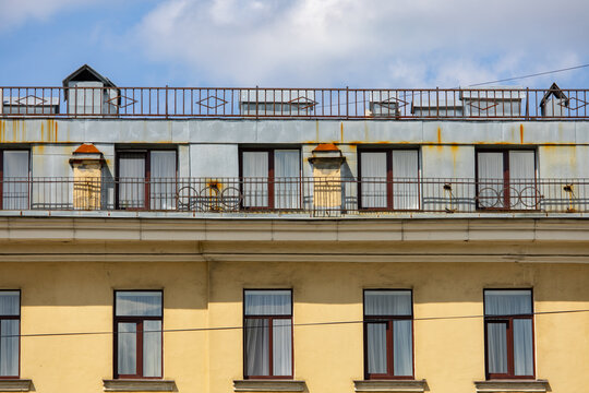 Weathered apartment building exterior with rusty balcony railings