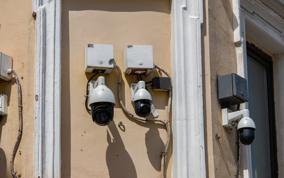Security cameras mounted on an old building facade