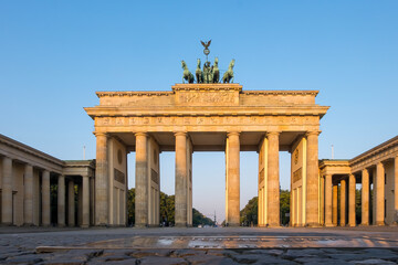 Brandenburg Gate at sunrise in Berlin, Germany with golden morning light © roobcio