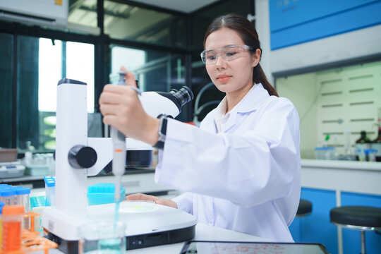 Laboratory Scientist Analyzing Samples with Microscope for Chemical Research