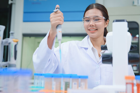 Scientist Performing Chemical Analysis with Pipette in Laboratory