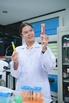 Chemist Evaluating Test Tubes in Advanced Laboratory Setting