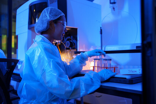 Scientist Conducting Chemistry Research in Laboratory with Protective Gear