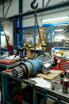 Motor rotor suspended from a chain hoist