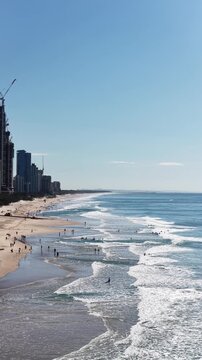 Surfers Paradise aerial footage of the city skyline meeting the Pacific Ocean, Gold Coast, Queensland Australia - vertical video