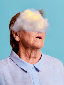 Luminous cumulus cloud replacing the face of a senior woman, featuring weathered skin and a pale linen shirt for conceptual art and identity layouts