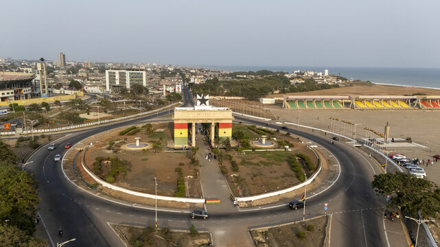 Aerial view of Black Star Square featuring the Independence Arch with surrounding roads, stadium, and coastline in Accra, Greater Accra Region, Ghana.
