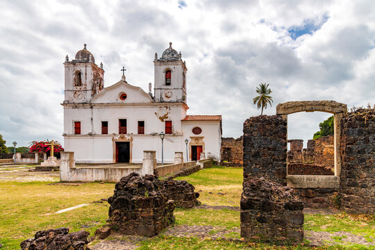 Historic church surrounded by stone ruins in the old city of Alcantara, Maranhao.