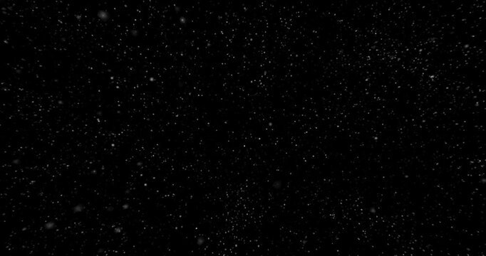 Falling snow flakes rain drops gentle particles drifting down looping