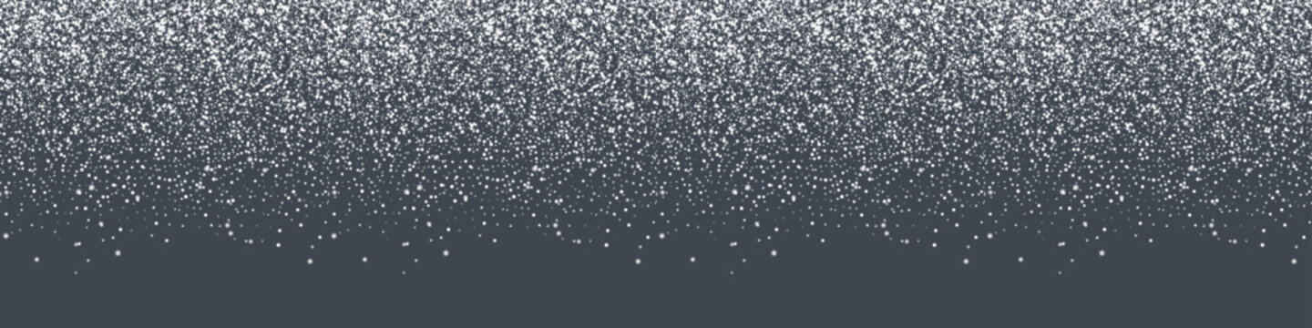 A dense cascade of white snowflakes drifts down against a dark gray backdrop, creating a winter wonderland effect