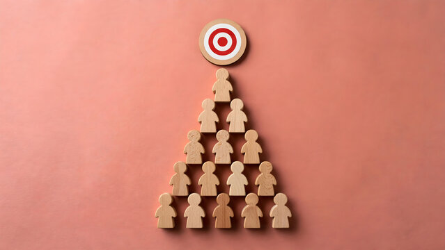 Wooden people figures arranged in pyramid hierarchy beneath target symbol on coral background