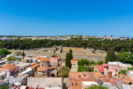 Rhodes, Greece - 16 May 2026: View of historic medieval walls and stone architecture of the Old Town under a clear blue sky.